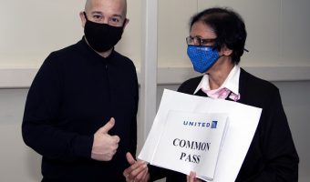 Traveler with mask and and airline personnel